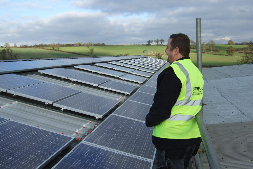 Steve Rudkin engineer inspecting a commercial solar PV array