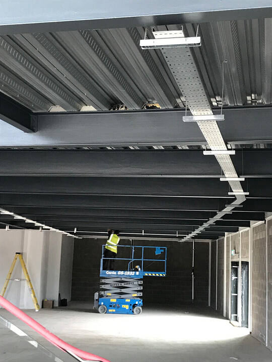 Surface mounted cable tray in a bike shop